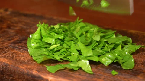 Chef cuts sorrel with a knife Stock Footage 253718219
