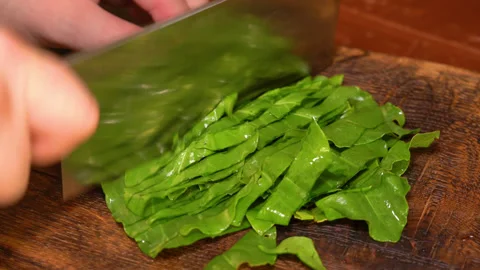Chef cuts sorrel with a knife Stock Footage 253718467