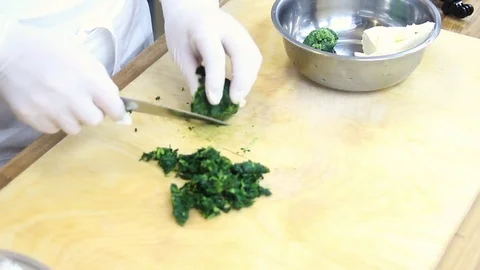 Chef cuts the spinach on the board Stock Footage 70003948