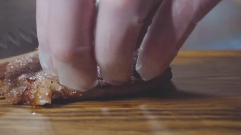 Chef cuts the steak in half Stock Footage 73816383