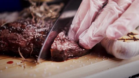 Chef cuts steak on a wooden board Vídeo Stock 159057953