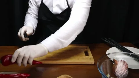 Chef cuts off the stem of the red pepper Stock-Footage 190074867