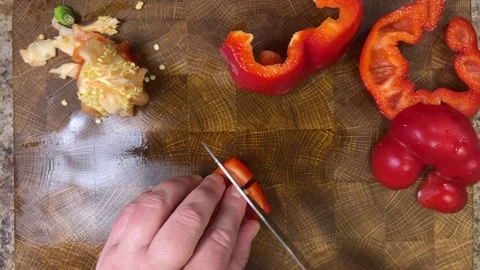 Chef cuts sweet round pepper with a knife on wooden cutting board. Stock-Footage 302270793