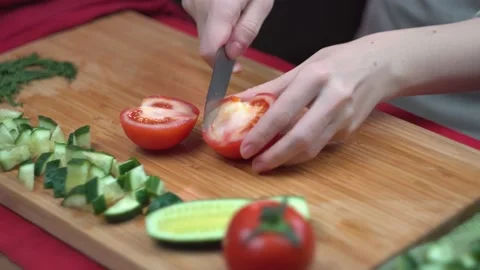 Chef cuts a tomato on a bamboo Board, healthy food, close-up, time laps, 5x spee Stock Footage 107317872