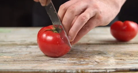 Chef cuts tomato on the Board Stock Footage 113423813