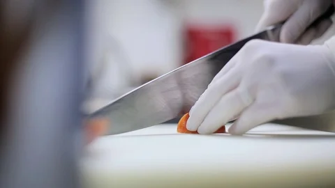 Chef cuts the tomato in gloves Stock Footage 70171631