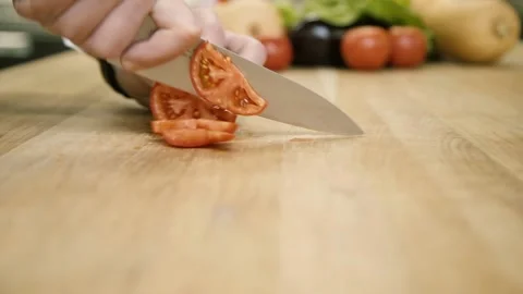 The chef cuts a tomato with a knife 스톡 동영상 148499366