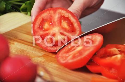 Chef cuts tomato Stock Photos