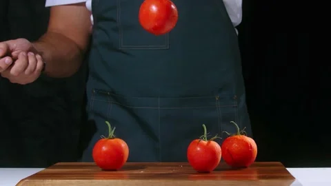 Chef cuts the tomato slow motion Stock Footage 223583302