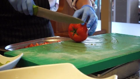 The chef cuts the tomatoes. Cut vegetables and greens as ingredients for sala Stock Footage 91719200