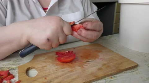 The chef cuts the tomatoes with a knife Stock Footage 138720049