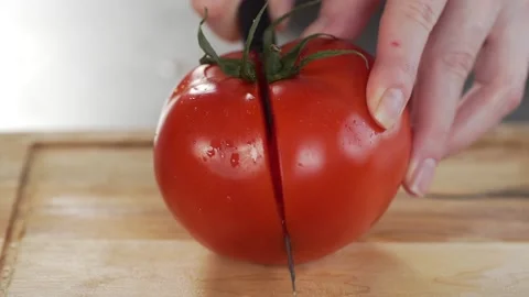 Chef cuts tomatoes for making vegetable dish fresh vegetable salad Stock Footage 143777556