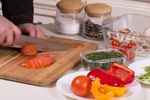 The chef cuts the tomatoes Stock Photos