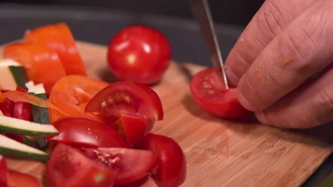 Chef cuts tomatoes for salad	 Stock Footage 157541334