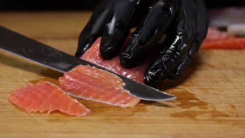 Chef cuts trout fillet into thin slices Stock Footage 122995164