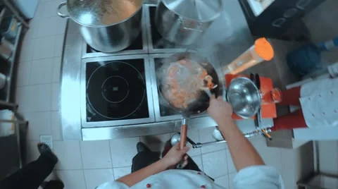 Chef cuts the vegetables and fry them in a pan Stock Footage 68386405