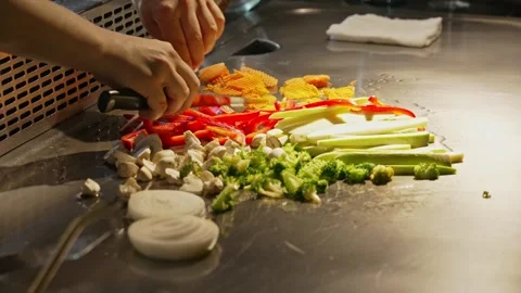 The chef cuts vegetables and roasts them in a frying pan. Mushrooms, onions Video stock 280177233