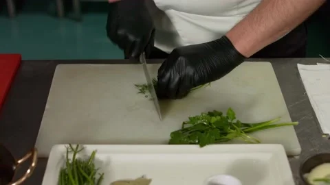 The chef cuts vegetables in the kitchen. Close up Stock Footage 131152022