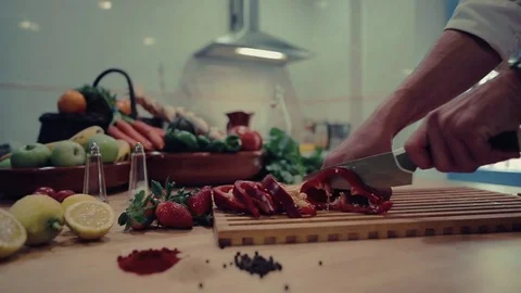 Chef cuts vegetables in kitchen Stock Footage 73898204