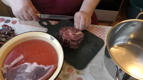 Chef cuts venison with a knife Stock Footage 169329436