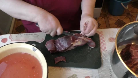 Chef cuts venison with a knife Stock Footage 169329749