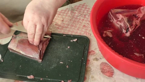 Chef cuts venison with a knife, raw deer meat Video stock 168050156