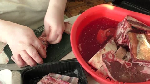 Chef cuts venison with a knife, raw deer meat Stock Footage 168050275