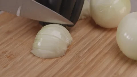 Chef cuts the white onion at cutting board. Stock Footage 312312352