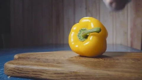 Chef cuts the yellow pepper in half Stock Footage 73816306