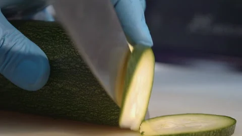 The chef cuts the zucchini into thin slices Stock Footage 158020320