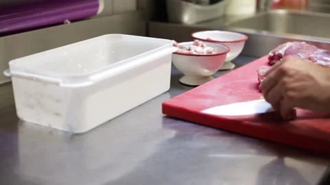 Chef cutting and cleaning meat Stock Footage 137945754