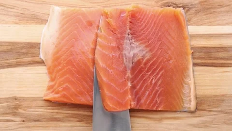 Chef Cutting and Opening Fresh Salmon Fillet on Wooden Board Stock Footage 308509891