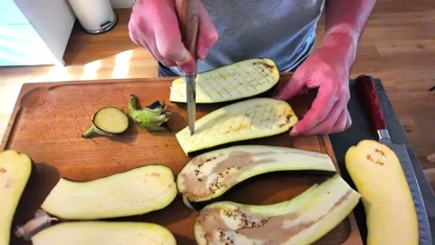 Chef cutting and scoring eggplants on cutting board 스톡 동영상 342985399