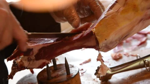 A chef cutting and serving Serrano ham on a plate Stock Footage 152303384