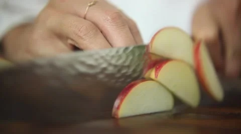 Chef cutting an apple with shallow depth of field Stock Footage 59888431