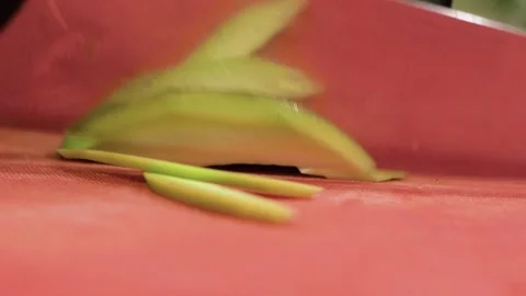Chef cutting avocado with a knife on cutting board Stock Footage 148085511