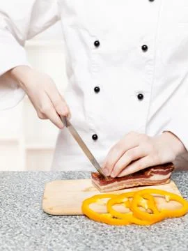 Chef cutting bacon Stock Photos