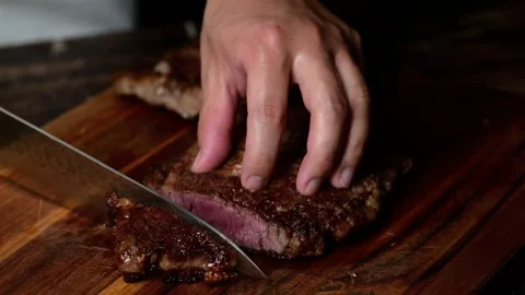 Chef cutting beef steak with knife Stock Footage 263769671