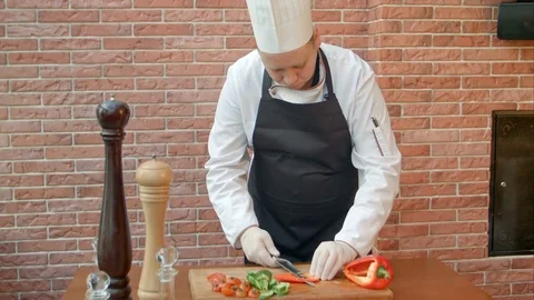 Chef cutting bell pepper for salad Stock Footage 74937058