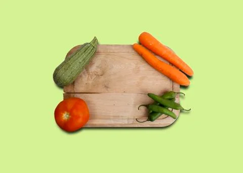 Chef cutting board accompanied by pumpkin, carrot, tomato and serrano pepper. Stock Photos