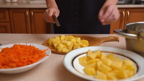 Chef cutting boiled potatoes with a wavy knife Stock Footage 328593841