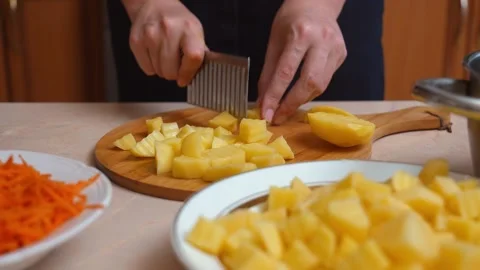 Chef cutting boiled potatoes with a wavy knife Stock Footage 328593978