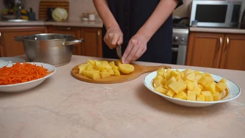 Chef cutting boiled potatoes with a wavy knife Stock Footage 328594154