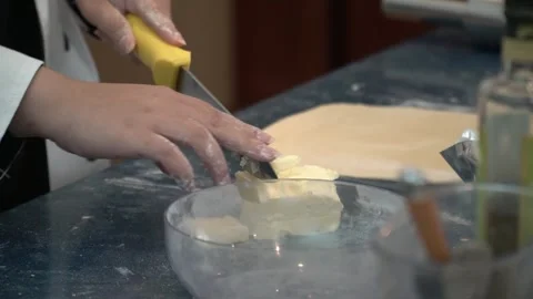 Chef Cutting Butter for Dough Stock Footage 317472575