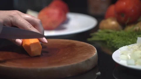 Chef cutting up an carrot with a knife Stock Footage 82592894