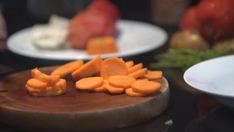 Chef cutting up an carrot with a knife Stock Footage 82592969