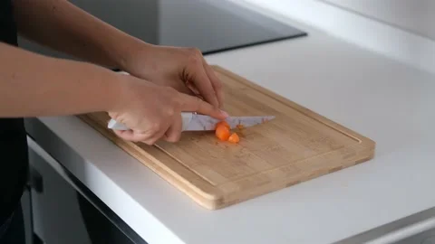 The chef is cutting carrots on the cutting board Stock Footage 146289735