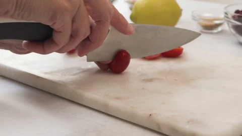 Chef cutting cherry tomatoes. Lettuce salad with cherry tomatoes recipe Stock Footage 138541644
