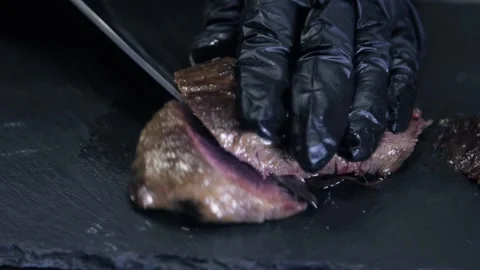 Chef Cutting Cooked Grilled Steak With Knife, Serves Platter With Meat And Stock Footage 146853584