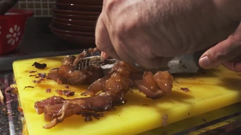 Chef cutting cooked pieces of meat for pilaf with a knife on a cutting board Stock Footage 280461626